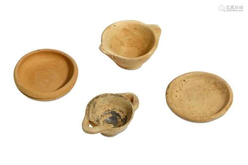 A GROUP OF FOUR MINIATURE TERRACOTTA VOTIVE VESSELS