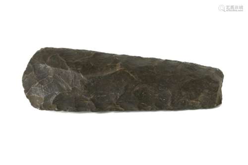 A NEOLITHIC TRAPEZOIDAL FLINT AXE HEAD Formed of black