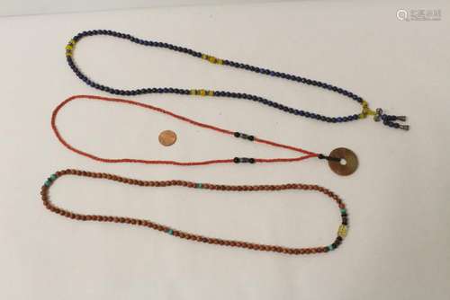 2 necklaces, and a jade disc with coral like necklace