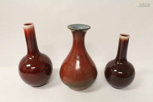 3 red glazed vases