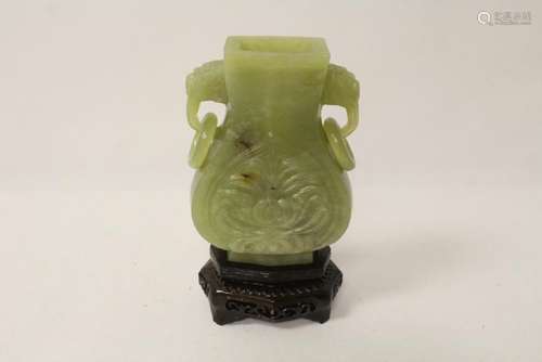 A green jade carved handled vase