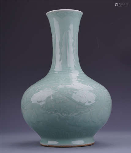 A Chinese Celadon Glazed Bottle Vase Carved with Floral Motif