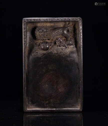 A STONE INK SLAB WITH LION CARVING