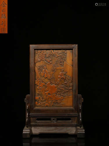 A RED WOOD SCREEN WITH LANDSCAPE CARVING