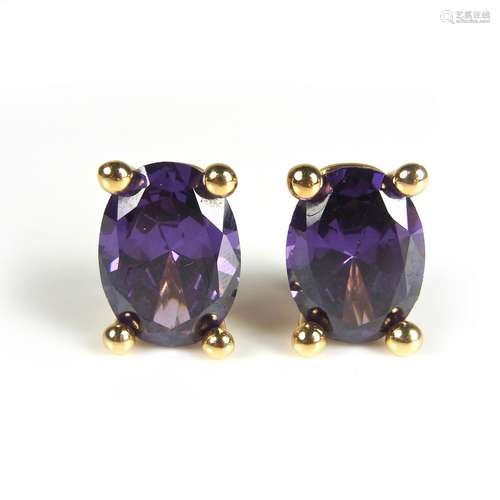 Yellow gold purple stone ear clips.