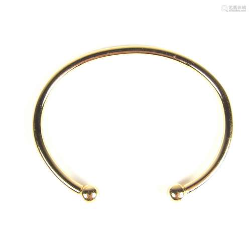 Yellow gold torque bangle.