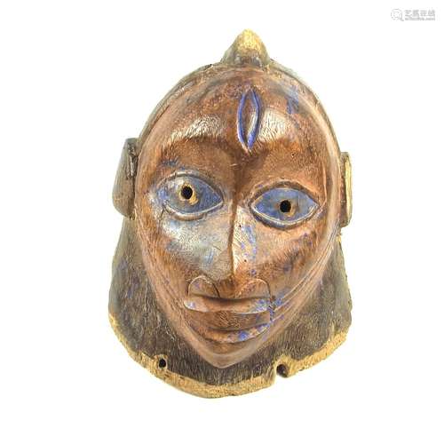 Tribal Art: An African carved wood helmet mask, Yoruba People, Nigeria, early 20th century.