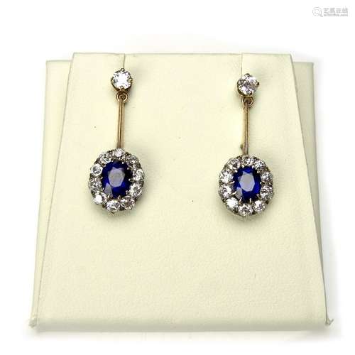 Yellow gold sapphire and diamond cluster drop earrings.