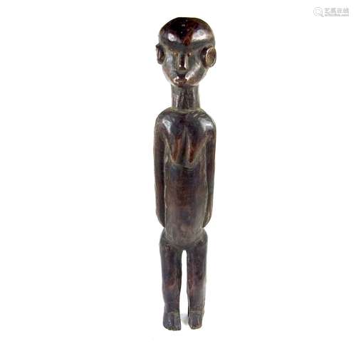 Tribal Art: An East African carved wood Nyamwesi standing figure, Tanzania, late 19th century.