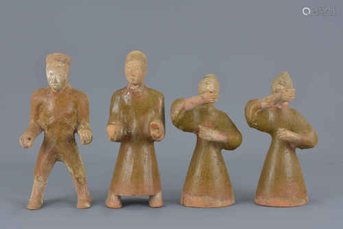 A set of four Chinese Han dynasty 206 BC to – 220 AD brownish glaze pottery figures. 16Cm – 19cm tal