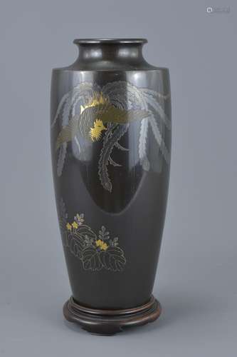 Japanese Bronze Vase with Inlaid Silver and Yellow Metal Decoration depicting a Phoenix on a Hardwoo