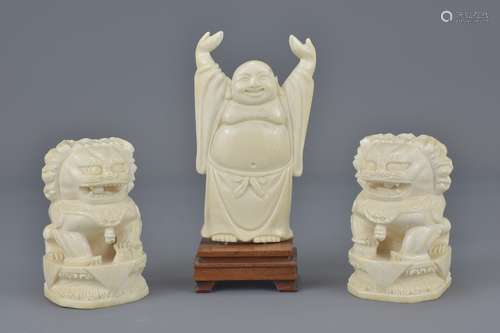 A pair of carved ivory Chinese dogs of foo with Chinese script to base on separate wooden stands tog