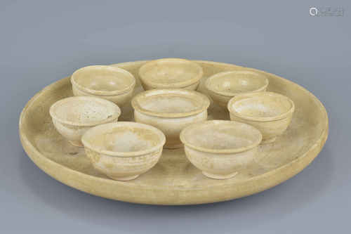 Chinese Tang dynasty 618-907 AD set of eight straw-glazed pottery cups and tray for ceremonial use.