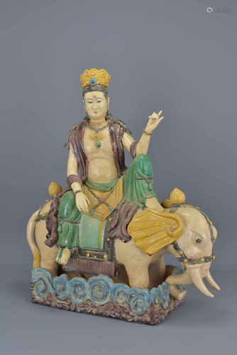 A Chinese sancai glazed pottery figure of Guanyin seated on an elephant. 48cm tall x 40cm width