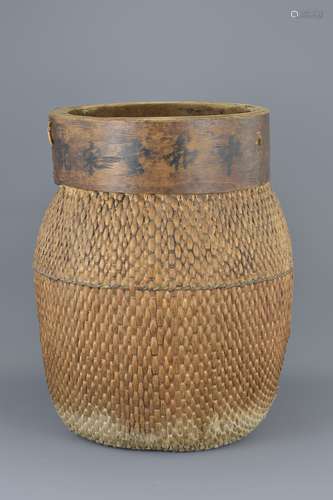 A large Chinese vintage wicker woven basket with five character Chinese shop mark to wooden frame wi