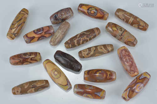 Seventeen Chinese Tianzhu style Dzi agate beads. 2-3cm length (17)