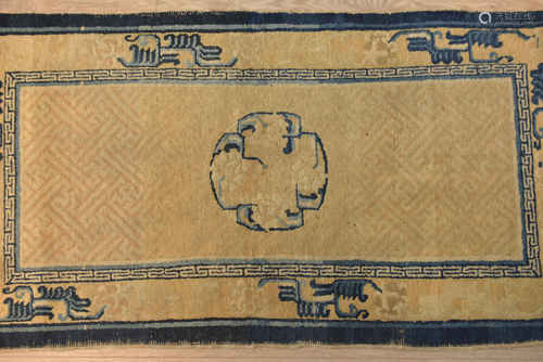 A late 19th century Tibetan meditation rug blue and white / gold border with central circular patter