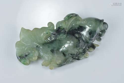 A large Chinese pale and dark jadeite pendant carved as a fish with a pearl in it's mouth. 9Cm x 4cm