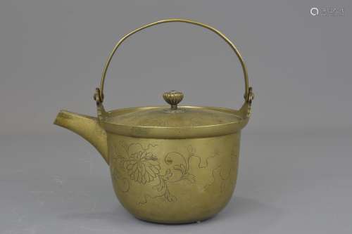 Japanese Edo Period Bronze Pitcher / Tea Kettle with Swing Handle and incised floral design, 19cms h