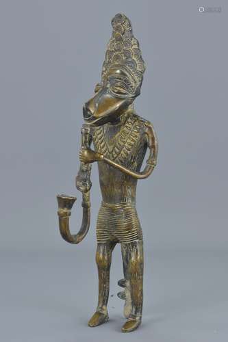 An West African standing bronze figure with pipe. 20Cm tall