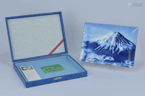 A Japanese 20th century rectangular porcelain enamel dish hand painted with Mount Fuji. In wooden di