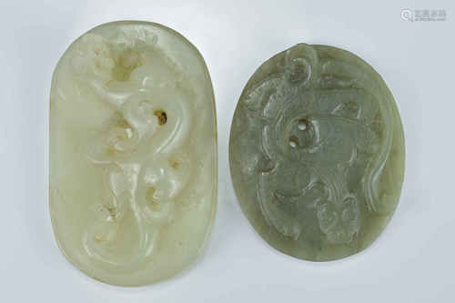 A Chinese pale celadon jade pendant surmounted with a carved dragon together with one other. 7Cm and