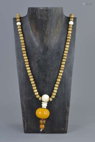 Ethnic Stone Bead Necklace with Pendant formed from Bone & Three Amber Style Beads, approximately 78