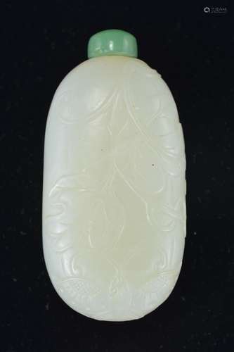 A Chinese 18/19th century white jade snuff bottle of long ovular form with incised decoration of but