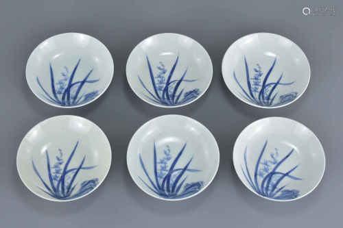 Six Small Japanese Porcelain Bowls, each with a white ground and decorated with blue reeds and flowe