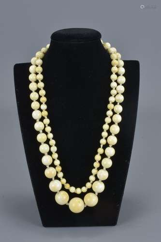 A long vintage graduated ivory beaded necklace. Total 145 beads. Largest bead approx. 2.3 cm diamete