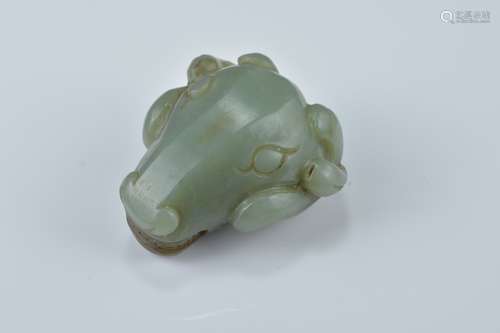 A Chinese dark green and brown jade pendant carved as a rams head. 5cm x 4.5cm