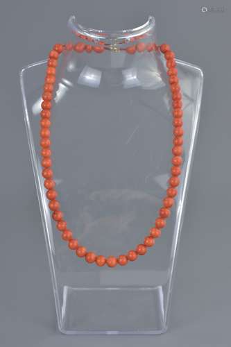 String of 58 ungraduated Coral Beads, 7mm diameter, 42cms long