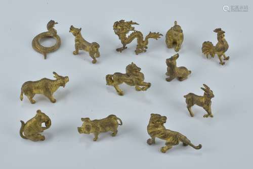 A set of twelve miniature yellow metal Chinese Zodiac figures. Approx. 1-1.5cm