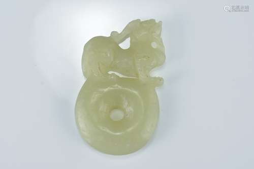 A Chinese pale celadon jade pendant carved with lion on disc. 6Cm tall x 3.5cm wide.