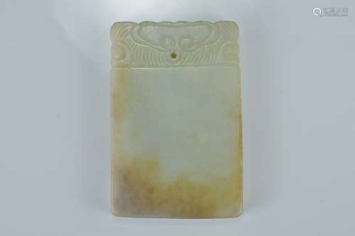 A Chinese pale celadon and russet jade plaque. Size 6.5cm x 4.5cm