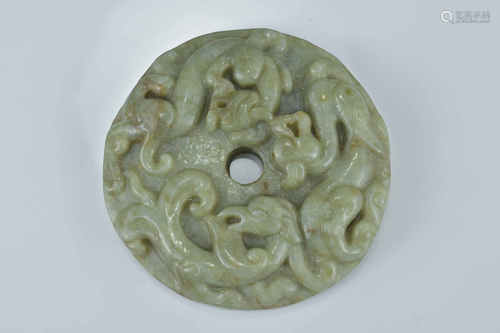 A large Chinese celadon jade jadeite bi disc carved with two dragons and one phoenix. 7Cm diameter