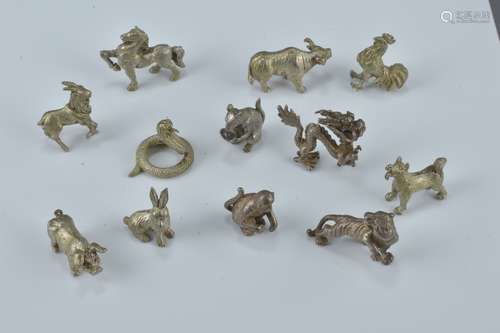 A set of twelve miniature silver metal Chinese Zodiac figures. Approx. 1-1.5cm