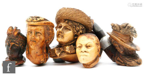 An early 20th Century carved figural Meerschaum pipe with hallmarked silver collar, formed as a fashionable lady wearing a bonnet, together with another silver collared exampled formed as an African man's head, and three other carved figural pipes in the form of ladies heads. (5)