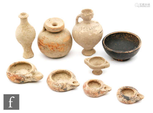 A collection of ancient Albanian Sier ware to include four painted terracotta lamps, two small jugs, an oil vase, a pedestal cup and a black painted bowl. (9)