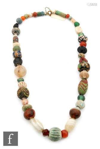 Roman 2nd to 4th Century AD - A string of multi coloured and polychrome glass beads, length 41cm