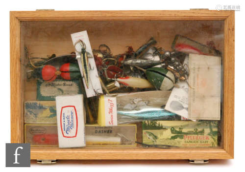 A collection of vintage fishing lures to include Swim Whizz 7, also Wright & McGill Miracle minnow, various plugs and floats in a glazed display case.