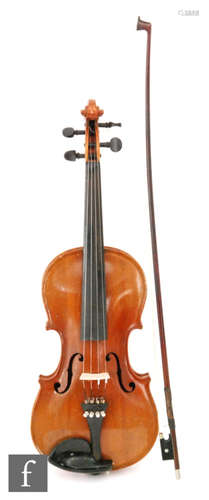 A 1920 to 1930s violin, the reverse stamped Stainer, length of back 35.5cm and with a bow, cased.