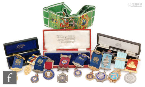 A 19th Century Masonic jewel with enamelled centre and paste set border with ribbon in recognition of service, dated 1877, a similar gilt jewel, a collection of eight RAOB jewels and a Foresters neck sash. (10)