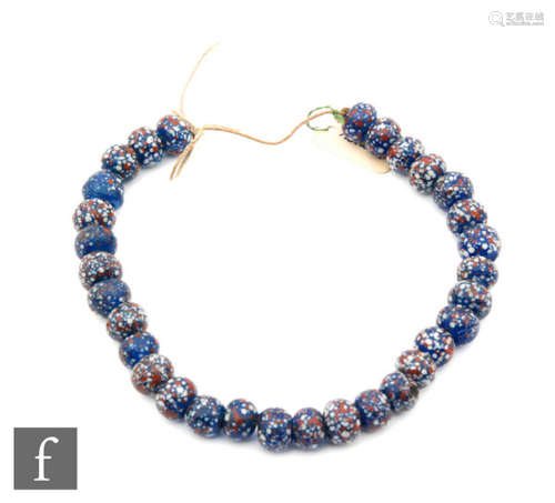 Roman 2nd to 4th Century AD - A string of speckle millefiori coloured glass beads, length 23.5cm