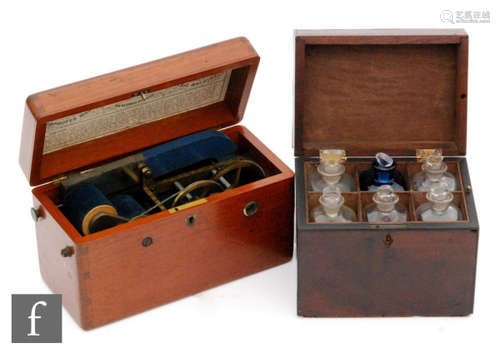 A 19th Century mahogany cased apothecary cabinet containing six bottles with one later blue example, width 18.5cm, and a Victorian mahogany cased Magneto-electric shock machine, width 25cm. (2)