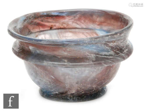 Roman 2nd to 4th Century AD - A purple and pale blue marbled effect cup with finger rim to body, 7cm diameter