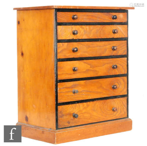 A Victorian stained pine and part ebonised collectors cabinet of six graduated drawers, turned wood handles, width 38cm