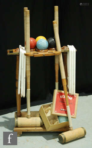 A mid 20th Century croquet set, the wooden stand complete with four A.G Spalding & Bros mallets, six hoops, a box of four Jacques Eclipse composite balls, two other balls, lacking the start and finish marker posts, S/D.