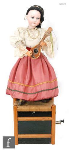 An Armand Marseille bisque head doll automaton of a girl in Italian dress playing a mandolin with moving arms and tapping her foot while standing on a chair, crank handle and pull button operation, height 74cm