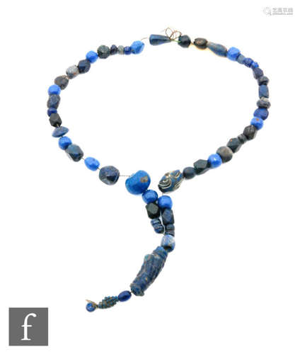 Roman 2nd to 4th Century AD - A string of lapis lazuli blue coloured beads with a spiral lentoid section, length 24cm